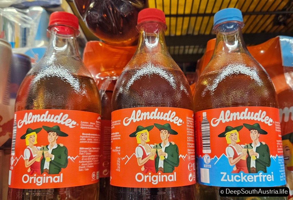 Large plastic bottles of Almdudler drink on Austrian supermarket shelf