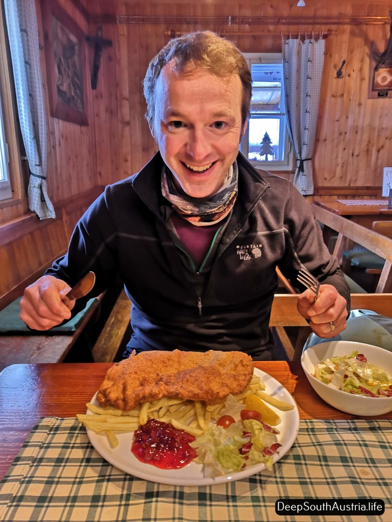 Man eats Wiener Schitzel in Austria