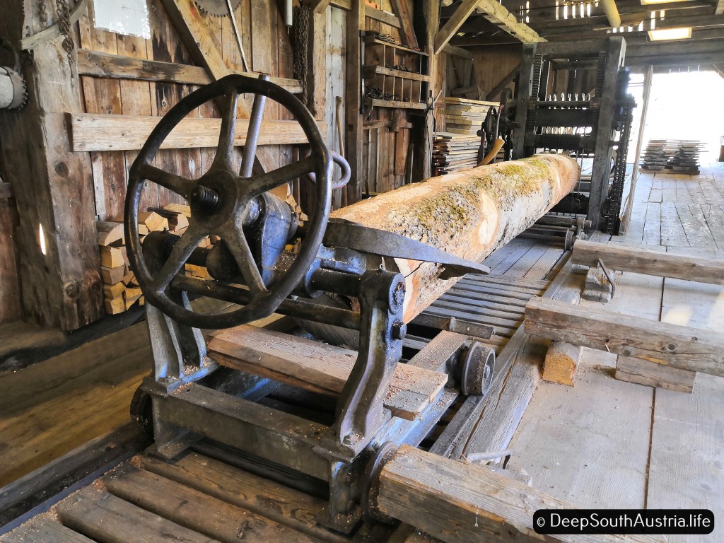 A trunk on a iron trolley in a saw mill