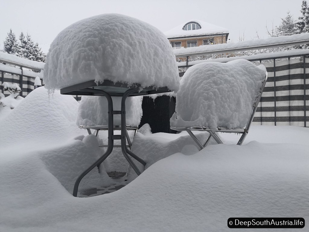 deep snow on a table and chair
